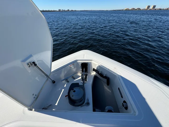  Yacht Photos Pics 2012 Boston Whaler 370 Outrage boat with open storage compartment on calm water.