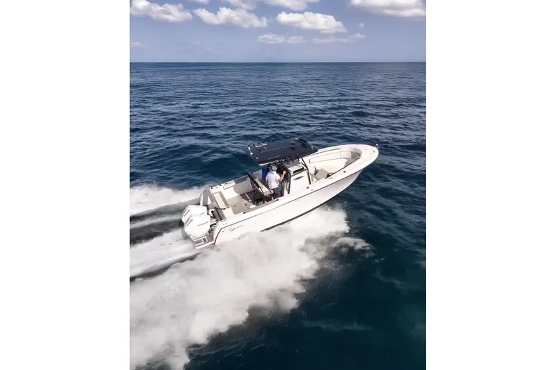  Yacht Photos Pics 2026 SeaWell 290CC boat cruising on open ocean under clear skies.