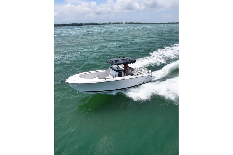  Yacht Photos Pics 2026 SeaWell 290CC boat cruising on open water under a clear sky.