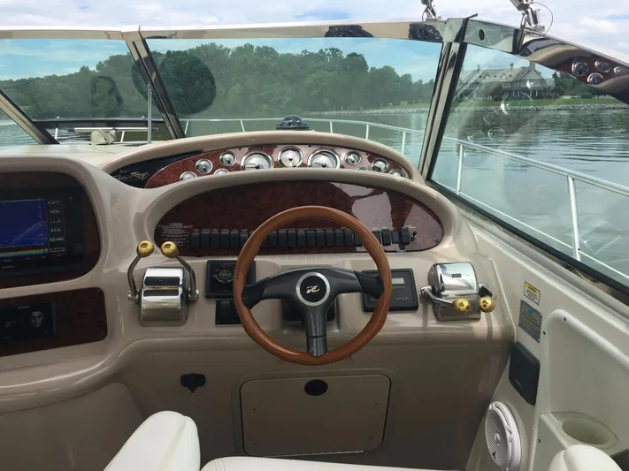  Yacht Photos Pics Helm of 2000 Sea Ray 410 Sundancer yacht with wooden steering wheel and control panel.