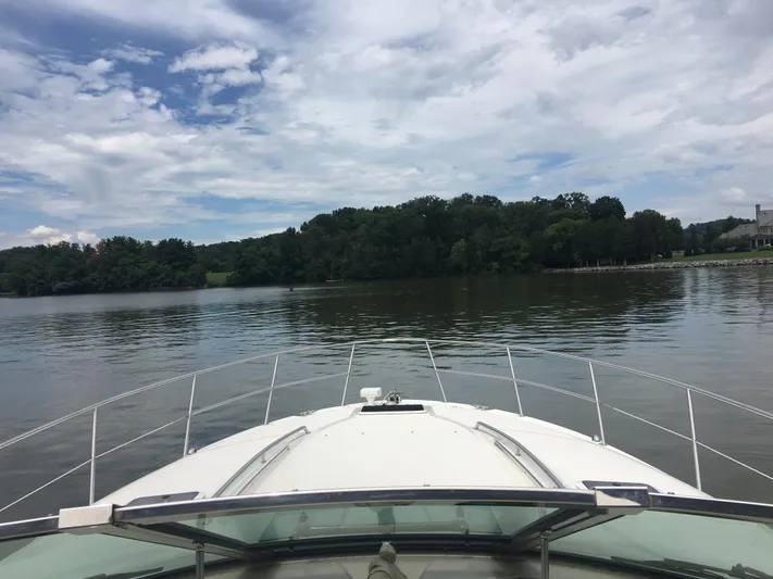  Yacht Photos Pics Bow view from a 2000 Sea Ray 410 Sundancer on a calm lake under a cloudy sky.