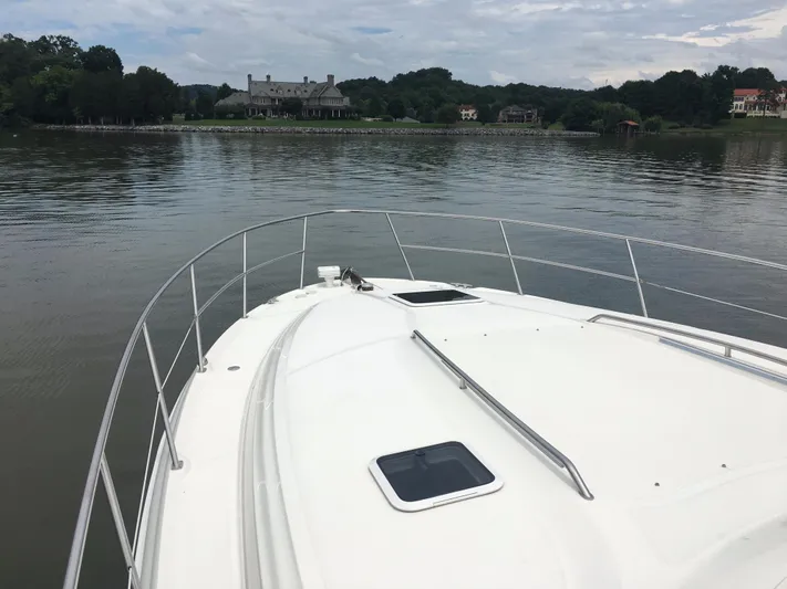  Yacht Photos Pics Bow view of 2000 Sea Ray 410 Sundancer on calm water near shoreline.