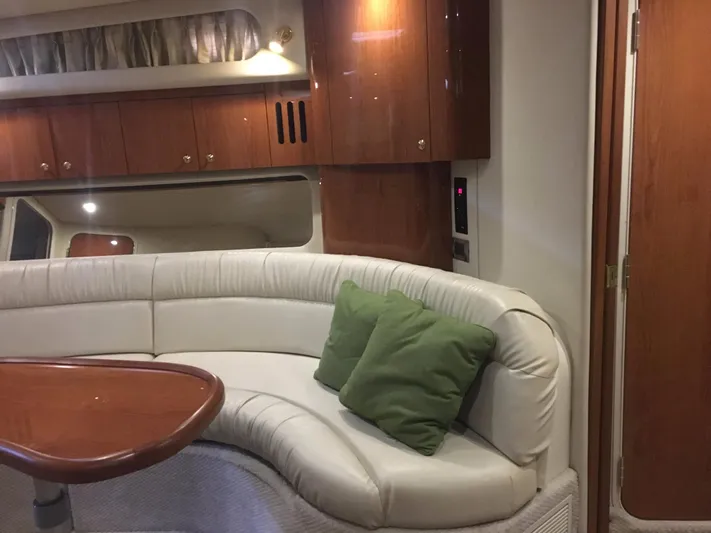  Yacht Photos Pics Interior of 2000 Sea Ray 410 Sundancer with white leather seating and wooden cabinetry.
