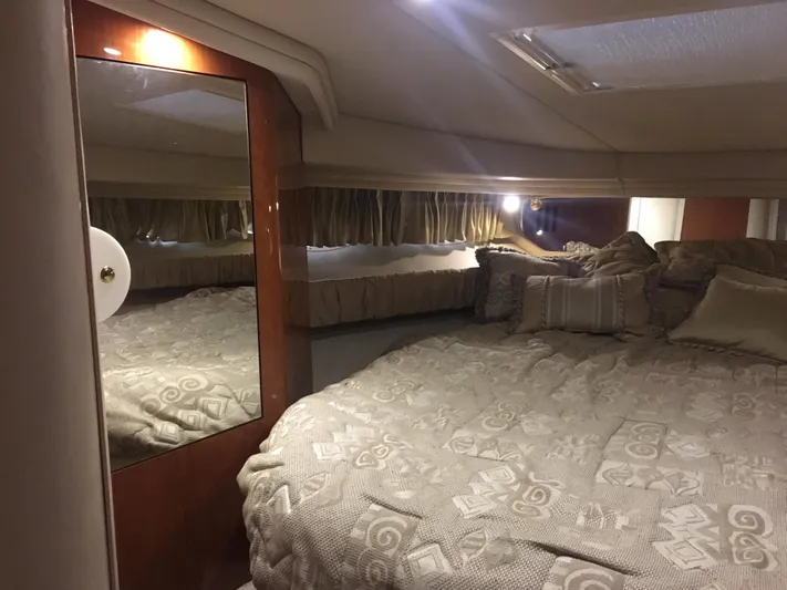  Yacht Photos Pics Interior cabin of 2000 Sea Ray 410 Sundancer with cozy bed and mirror.