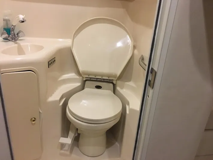 Yacht Photos Pics Bathroom interior of 2000 Sea Ray 410 Sundancer yacht, featuring a compact toilet and sink.