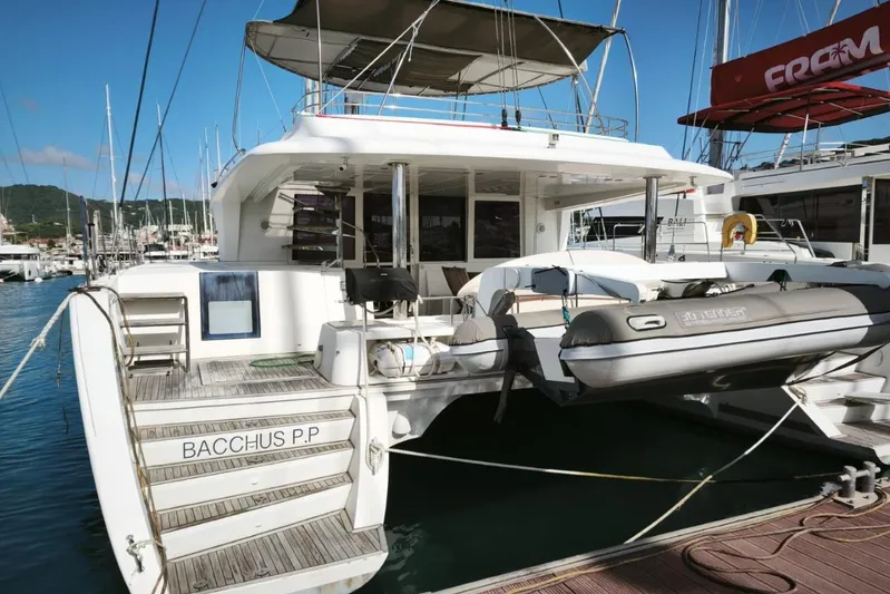  Yacht Photos Pics 2012 Lagoon 560 yacht docked at marina with inflatable boat attached.