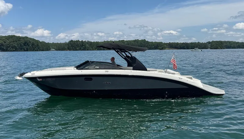  Yacht Photos Pics 2020 Sea Ray 290SDX boat on a lake with clear skies and distant trees.