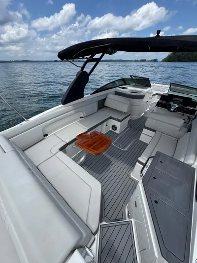  Yacht Photos Pics 2020 Sea Ray 290SDX boat interior with seating, table, and canopy on a sunny day.