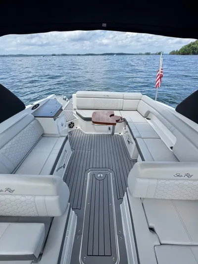  Yacht Photos Pics 2020 Sea Ray 290SDX boat interior with spacious seating on a calm lake.