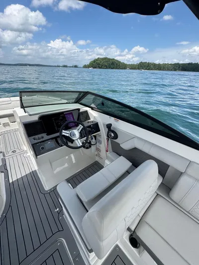  Yacht Photos Pics 2020 Sea Ray 290SDX boat interior with steering wheel, on a sunny day at sea.
