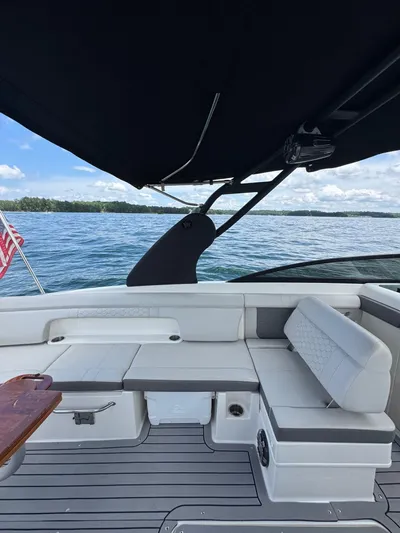  Yacht Photos Pics 2020 Sea Ray 290SDX boat interior with seating, canopy, and scenic water view.
