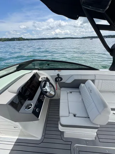 Yacht Photos Pics 2020 Sea Ray 290SDX boat interior with helm and seating, on a serene lake.