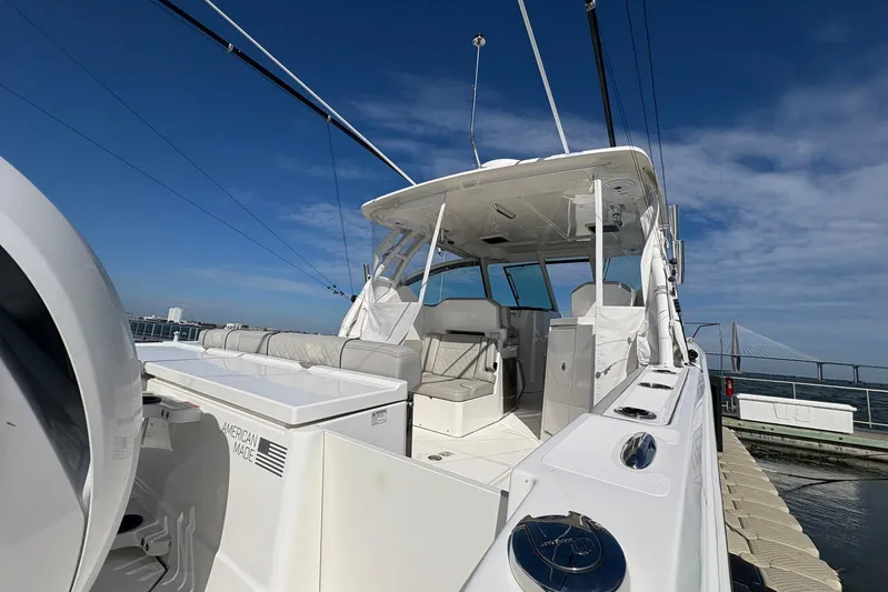 Sheminem Yacht Photos Pics 2023 Pursuit DC 295 Dual Console boat docked under clear blue sky.