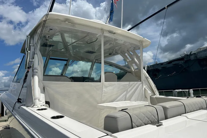 Sheminem Yacht Photos Pics 2023 Pursuit DC 295 Dual Console boat docked under cloudy sky.