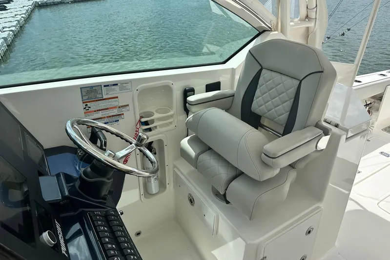 Sheminem Yacht Photos Pics 2023 Pursuit DC 295 Dual Console helm with luxury seating and steering wheel.