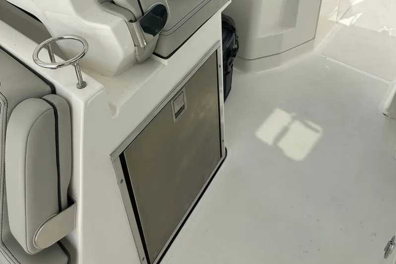 Sheminem Yacht Photos Pics 2023 Pursuit DC 295 Dual Console interior with seating and storage compartment.