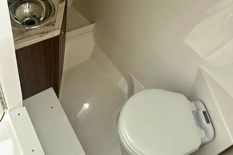 Sheminem Yacht Photos Pics 2023 Pursuit DC 295 Dual Console boat bathroom with sink and toilet.