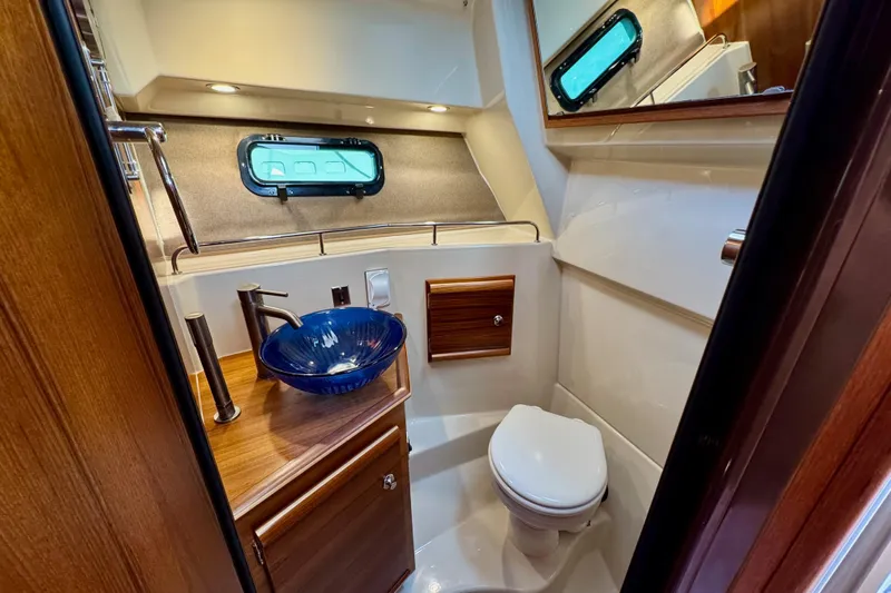 Noodles Yacht Photos Pics Luxurious 2024 Ranger Tugs R-27 bathroom with modern sink and elegant wood accents.