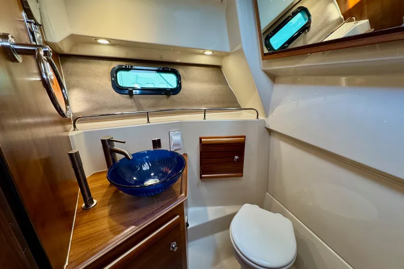 Noodles Yacht Photos Pics Luxurious 2024 Ranger Tugs R-27 bathroom with modern sink and elegant wood accents.