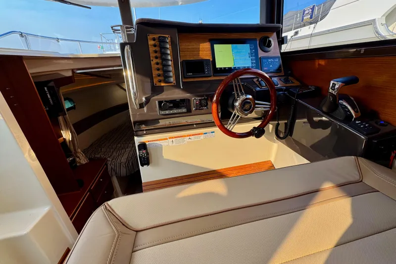 Noodles Yacht Photos Pics 2024 Ranger Tugs R-27 helm with navigation controls and cozy cabin interior.