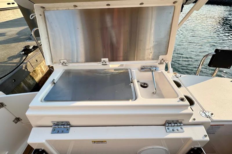 Noodles Yacht Photos Pics 2024 Ranger Tugs R-27 boat sink and storage compartment, open lid, dockside view.