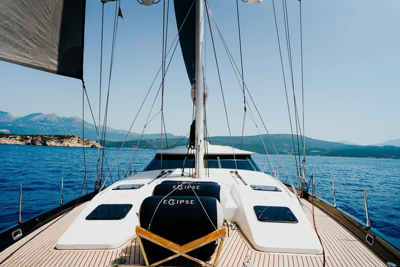 Eclipse Yacht Photos Pics Luxury yacht deck of 1991 Alloy Yachts Dubois Design, sailing on clear blue waters.