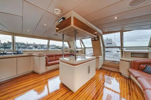 Eclipse Yacht Photos Pics Luxurious interior of 1991 Alloy Yachts Dubois Design with polished wood floors and leather seating.