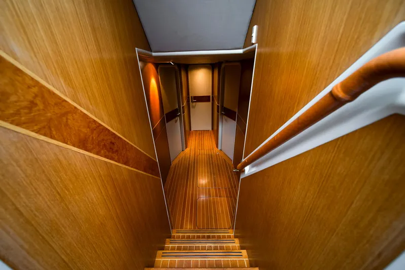 Eclipse Yacht Photos Pics Luxurious wooden interior of 1991 Alloy Yachts Dubois Design, featuring elegant hallway and staircase.