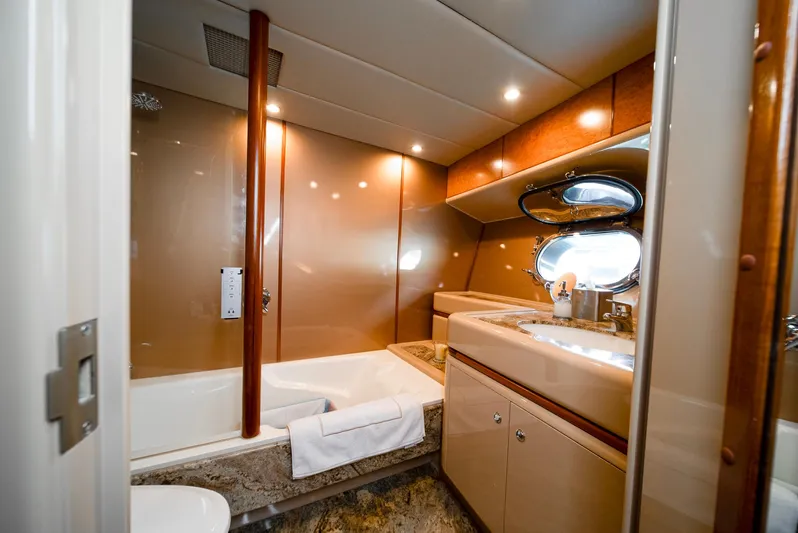 Eclipse Yacht Photos Pics Luxurious yacht bathroom with modern fixtures, featuring a bathtub and porthole windows. Alloy Yachts Dubois Design 1991.