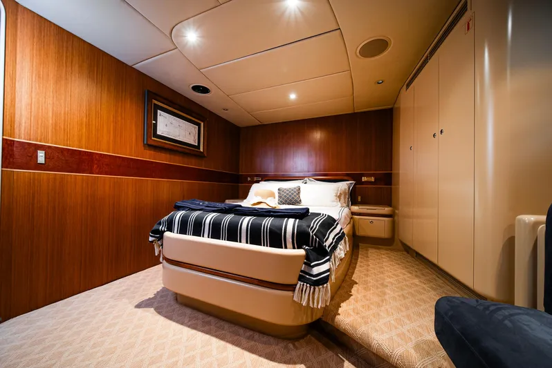 Eclipse Yacht Photos Pics Luxurious bedroom interior on 1991 Alloy Yachts Dubois Design, featuring elegant wood paneling.