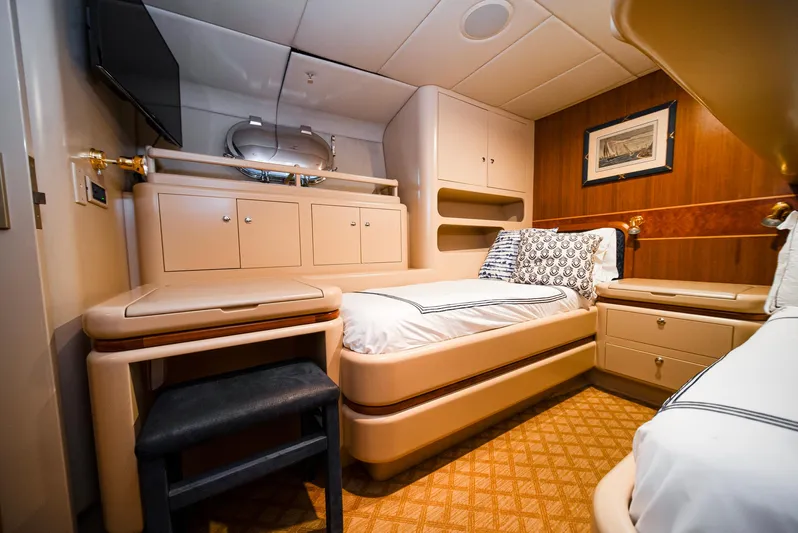 Eclipse Yacht Photos Pics Luxurious cabin interior of 1991 Alloy Yachts Dubois Design, featuring elegant furnishings and cozy bedding.