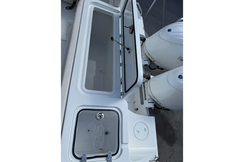  Yacht Photos Pics 2024 Sea Hunt Gamefish 27 boat with open storage compartment and dual outboard engines.