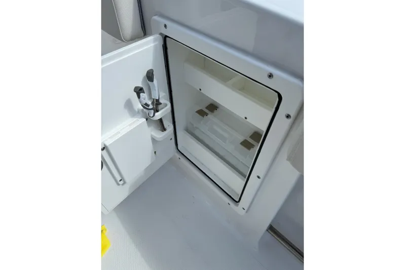  Yacht Photos Pics 2024 Sea Hunt Gamefish 27 Forward Seating storage compartment with open door and tool holder.