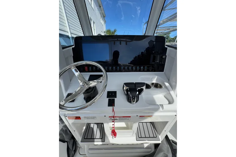  Yacht Photos Pics 2024 Sea Hunt Gamefish 27 helm with steering wheel and control panel.