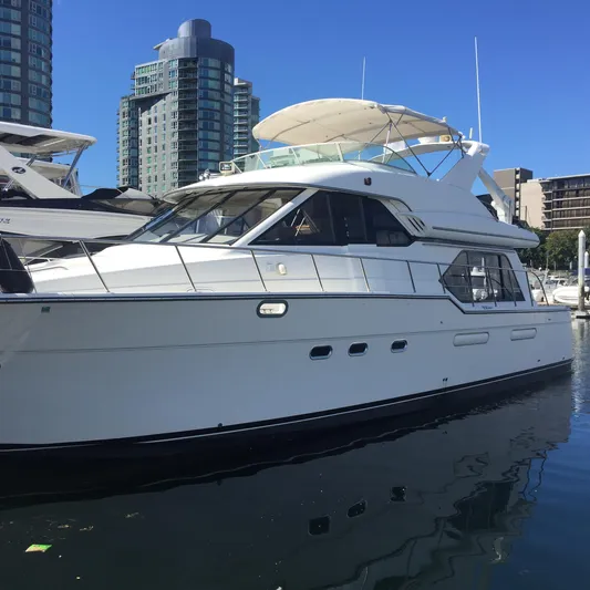 Solana Yacht Photos Pics 2000 Bayliner 5288 Pilot House Motoryacht docked in urban marina setting.