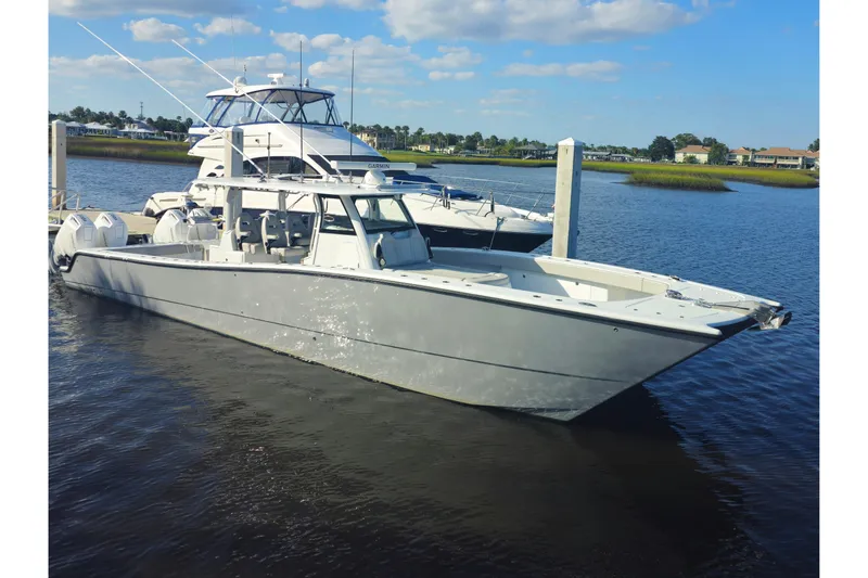  Yacht Photos Pics 2022 Freeman 47 boat docked on calm water under a clear blue sky.