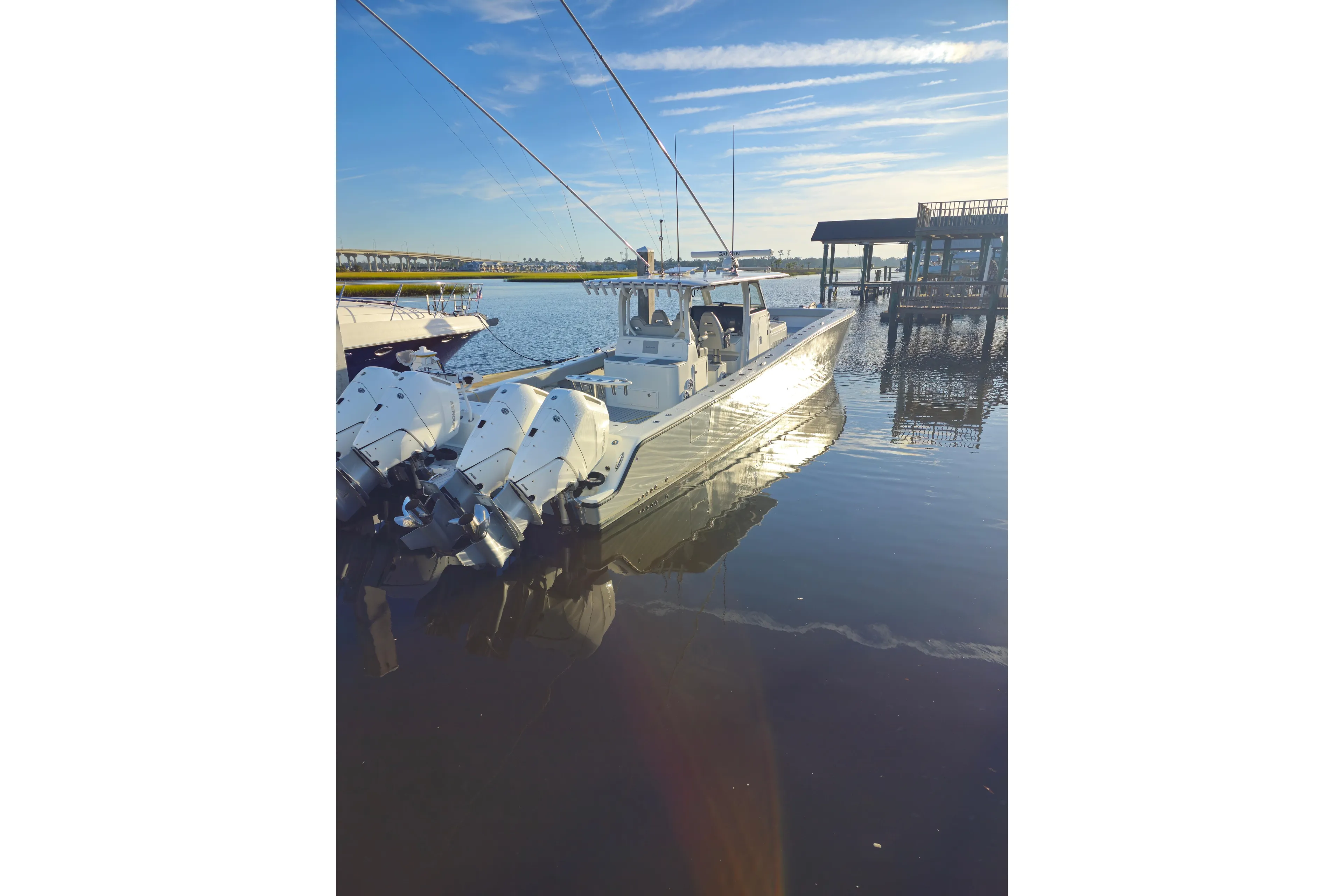  Yacht Photos Pics 2022 Freeman 47 boat docked on calm water under a clear blue sky.
