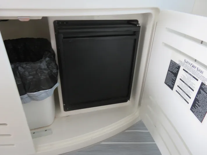 Yacht Photos Pics Cabinet interior of 2001 Sea Ray 510 Sundancer with trash bin and black panel.