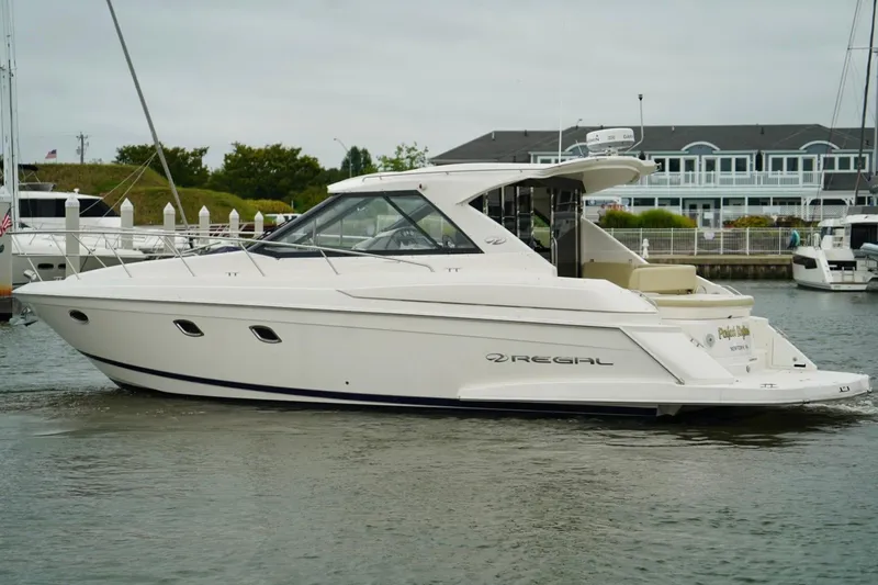 Yacht Photos Pics 2012 Regal 42 Sport Coupe yacht docked in a marina, side view.