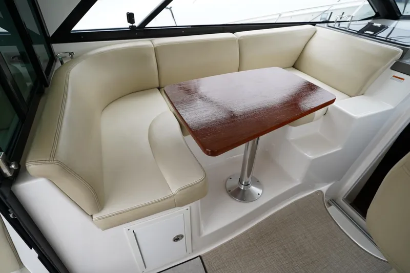  Yacht Photos Pics Luxurious seating area with wooden table on 2012 Regal 42 Sport Coupe yacht.