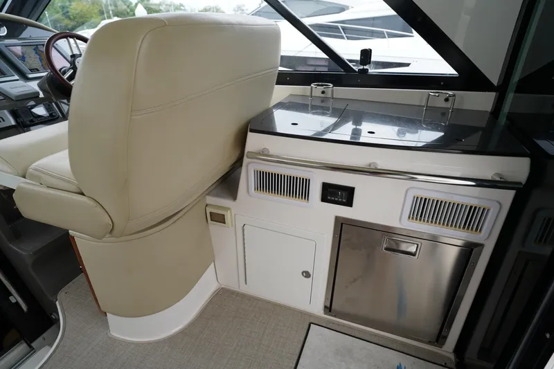  Yacht Photos Pics Interior of 2012 Regal 42 Sport Coupe with helm seat and kitchenette area.
