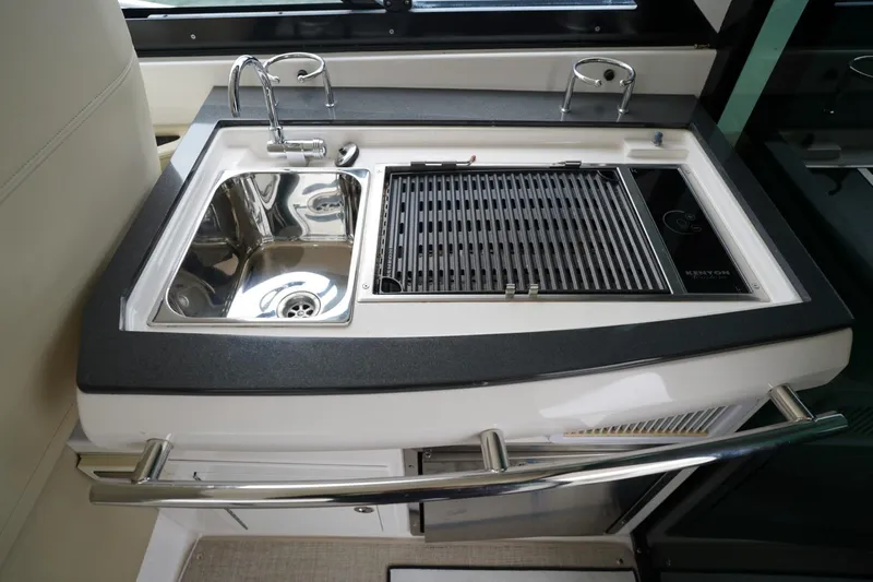  Yacht Photos Pics 2012 Regal 42 Sport Coupe yacht kitchenette with sink and grill.