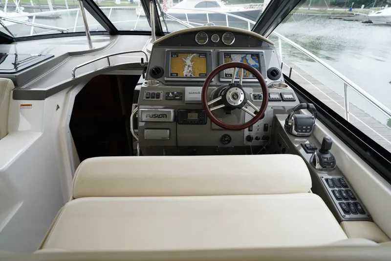  Yacht Photos Pics Cockpit of 2012 Regal 42 Sport Coupe with navigation screens and steering wheel.