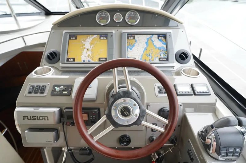  Yacht Photos Pics Cockpit of 2012 Regal 42 Sport Coupe with navigation screens and steering wheel.
