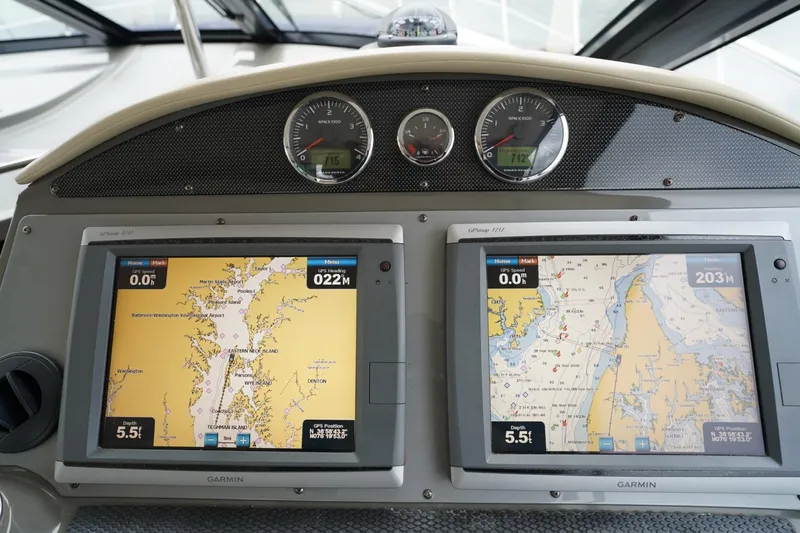  Yacht Photos Pics Dashboard of a 2012 Regal 42 Sport Coupe with navigation screens and gauges.