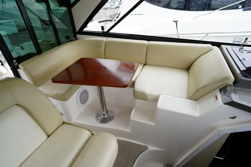  Yacht Photos Pics Luxurious interior of 2012 Regal 42 Sport Coupe with beige seating and wooden table.