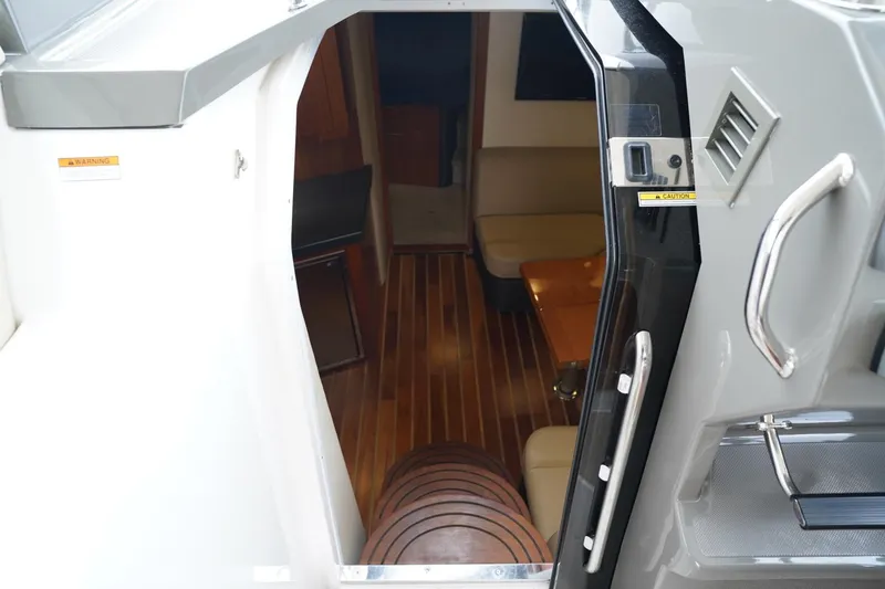  Yacht Photos Pics Interior view of 2012 Regal 42 Sport Coupe yacht, featuring wooden flooring and seating area.
