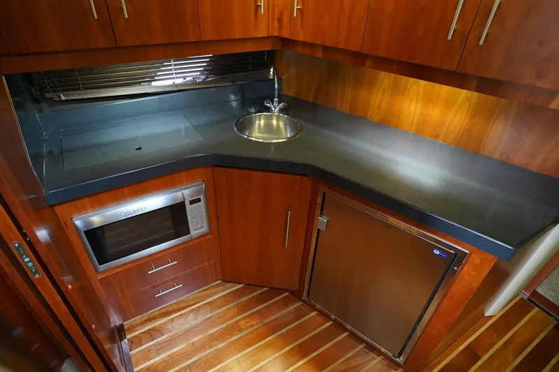  Yacht Photos Pics Luxurious galley in 2012 Regal 42 Sport Coupe with wood cabinetry and modern appliances.