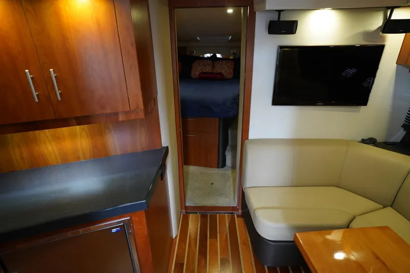  Yacht Photos Pics Interior of 2012 Regal 42 Sport Coupe with modern seating, TV, and wood cabinetry.