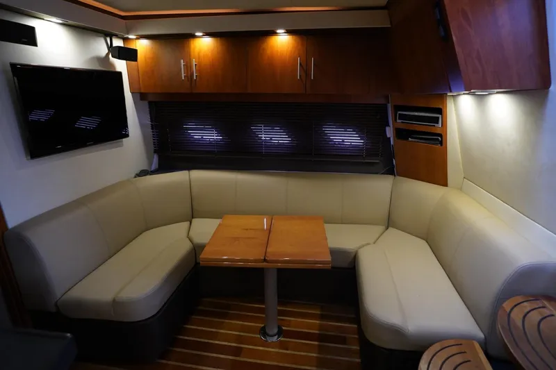  Yacht Photos Pics Luxurious interior of 2012 Regal 42 Sport Coupe with leather seating and wooden accents.